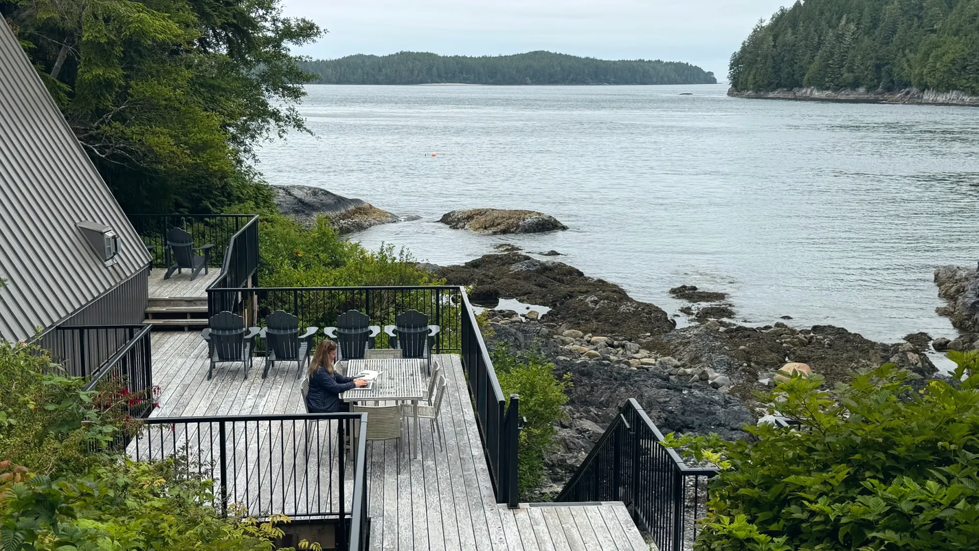 Shannon Huffman Polson writing on a deck above the water