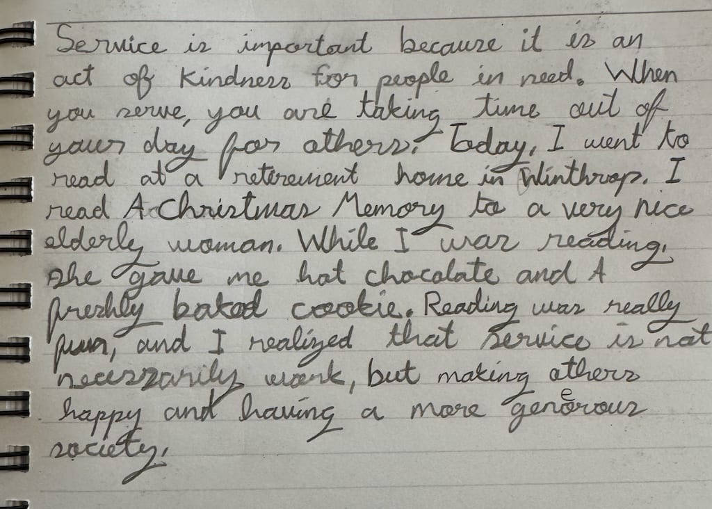 A handwritten reflection on service written by a young volunteer