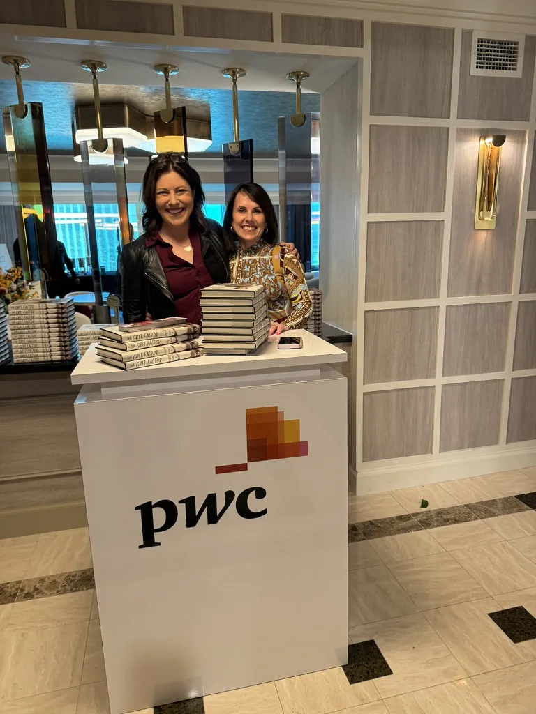 Shannon Huffman Polson at a PwC event with copies of The Grit Factor