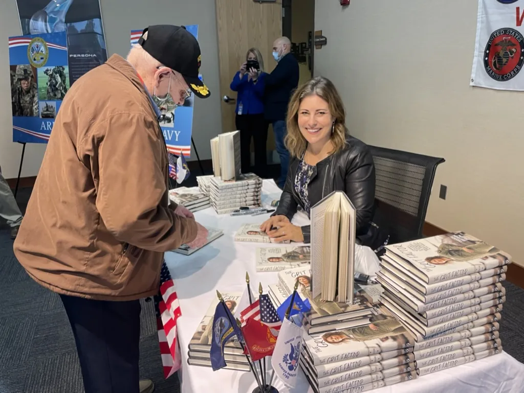 Shannon Huffman Polson: signing The Grit Factor for a veteran at a corporate speaking event